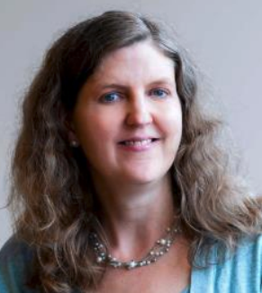 A headshot of Laura Hamilton, a female-presenting person, who smiles towards the camera.
