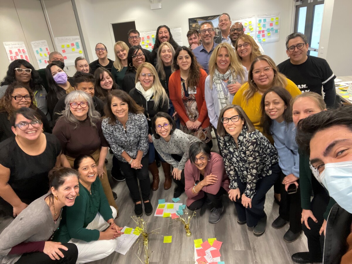 A group photo of the staff described in the blog, along with the artifacts of their SEL work. They are all smiling happily