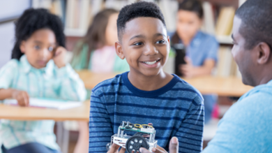 Photo of middle school boy talking to a teacher